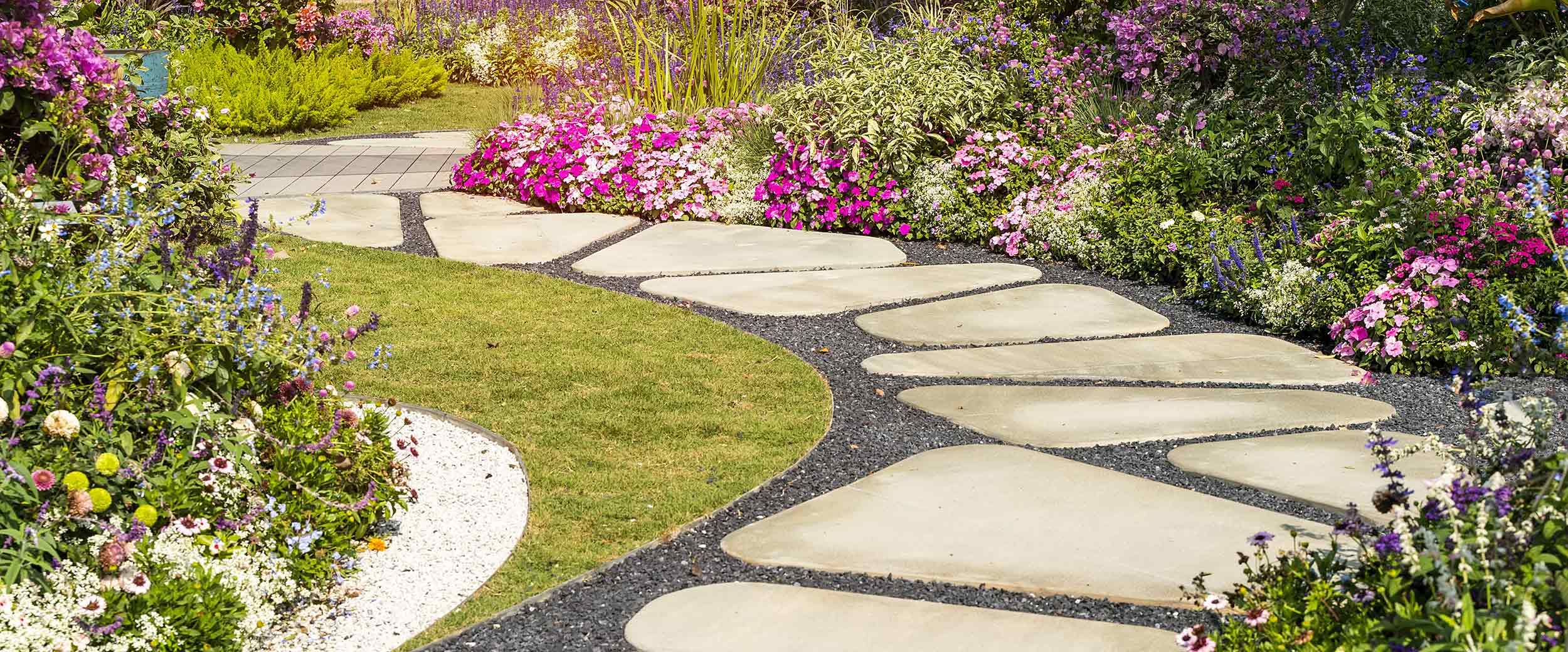 Flagstone path through garden by Finer Lawn & Landscaping