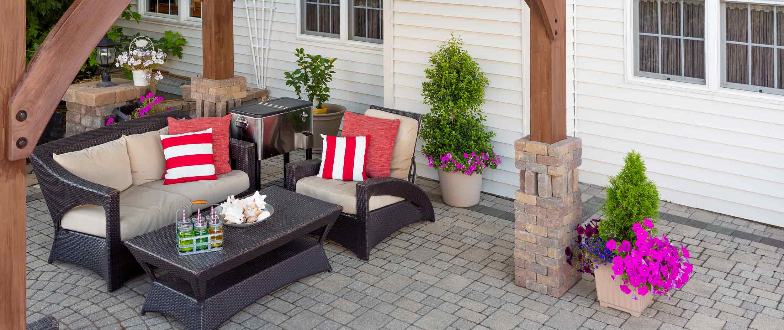 Paver patio with pergola by Finer Lawn & Landscaping