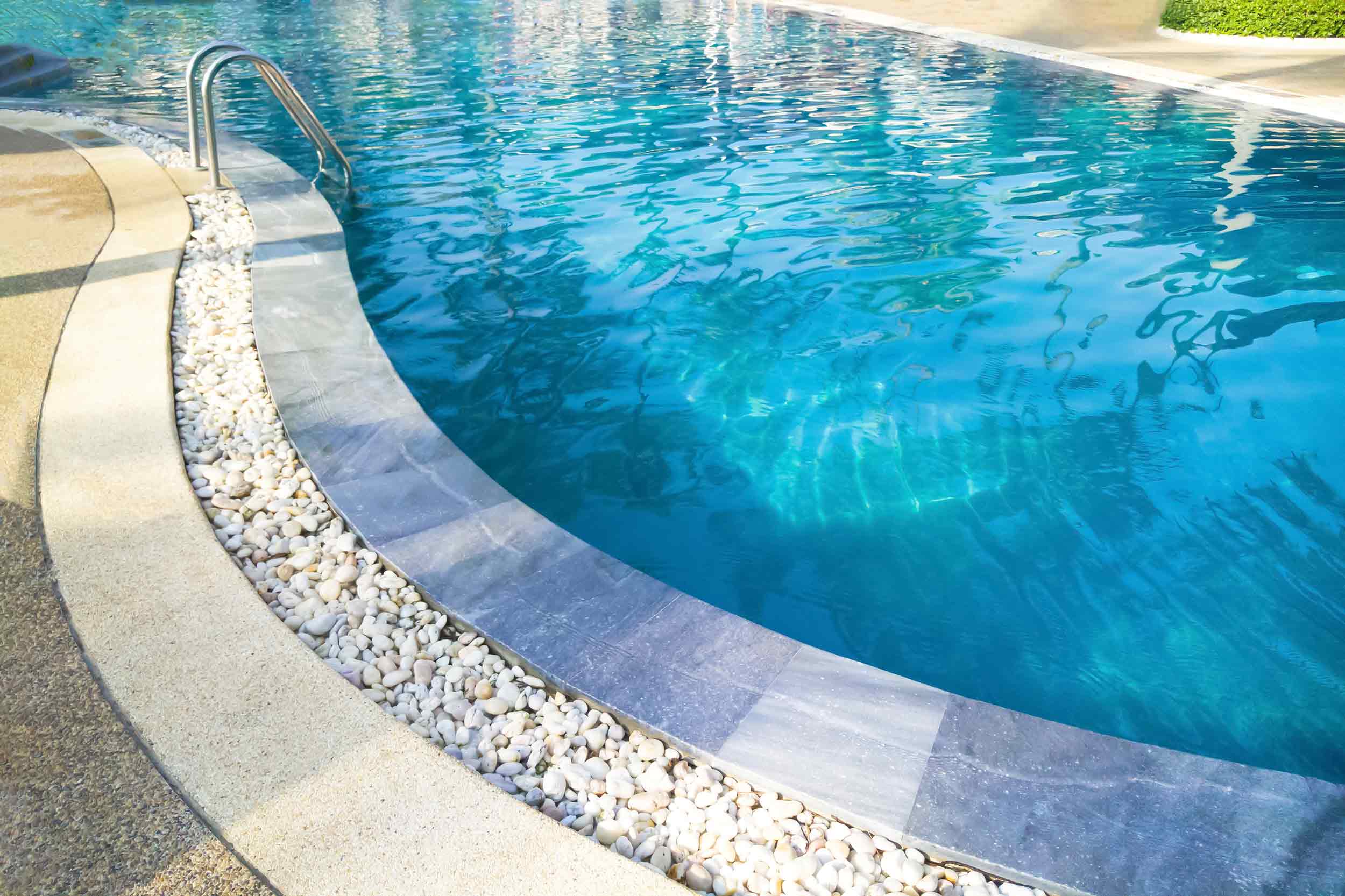 Pool Decking - Paver decking with landscaping rock.